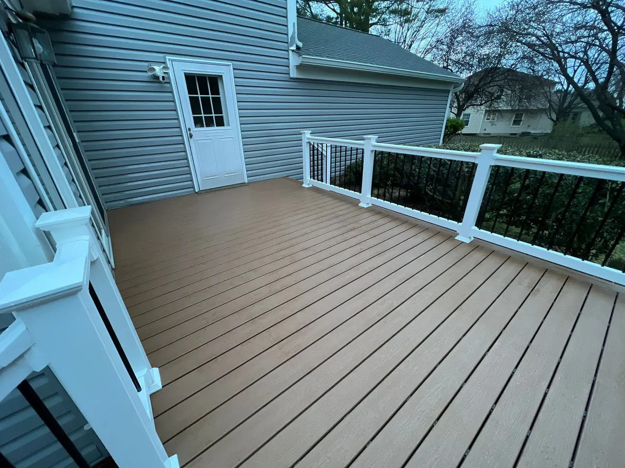 Tan composite deck install — Eagle Home Improvements